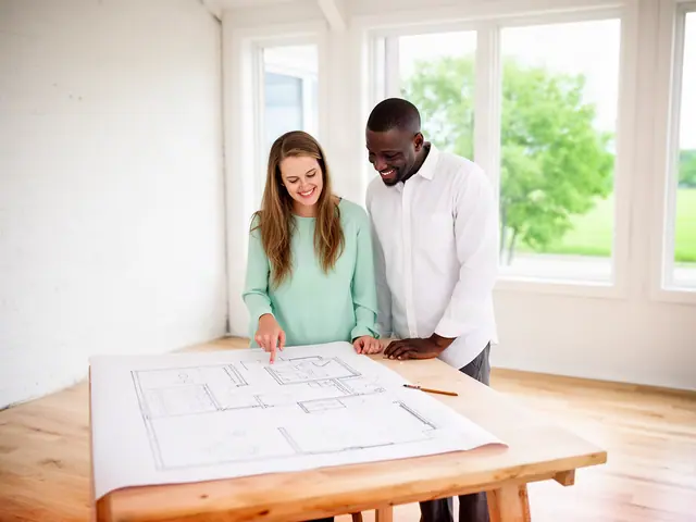 Two business partners looking over a pencil floor sketch in an empty storefront.